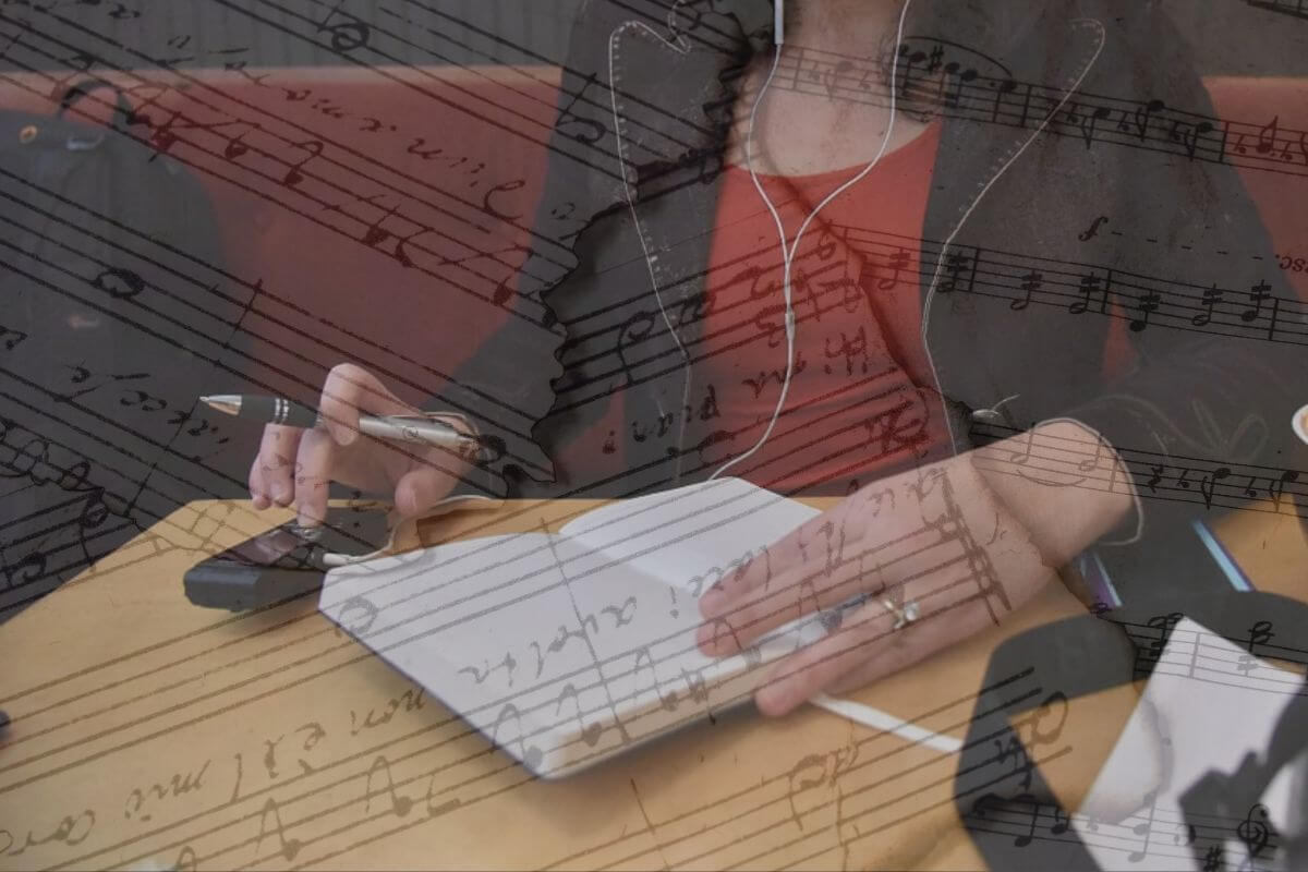 a photo of a person writing in a journal overlaid with faded sheet music