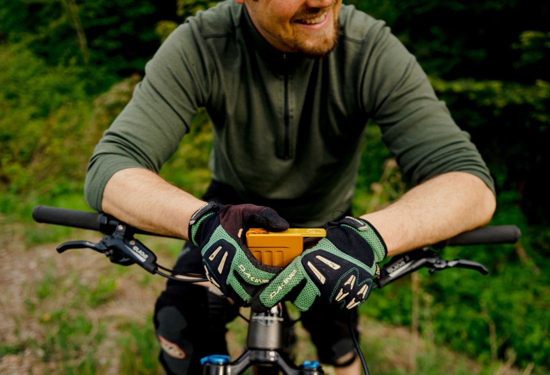 a man on a bike holding a joint case