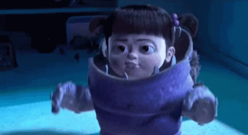 Boo, a young girl dressed in a monster costume from Monsters Inc., roars at you