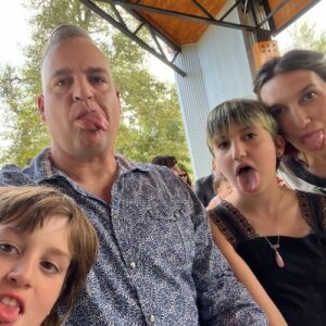 a family of four makes silly faces