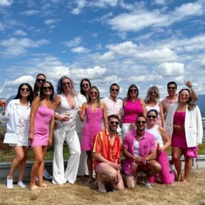 a group of people in pink and white outfits smile at the camera