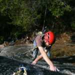 Mark climbing up a cliff